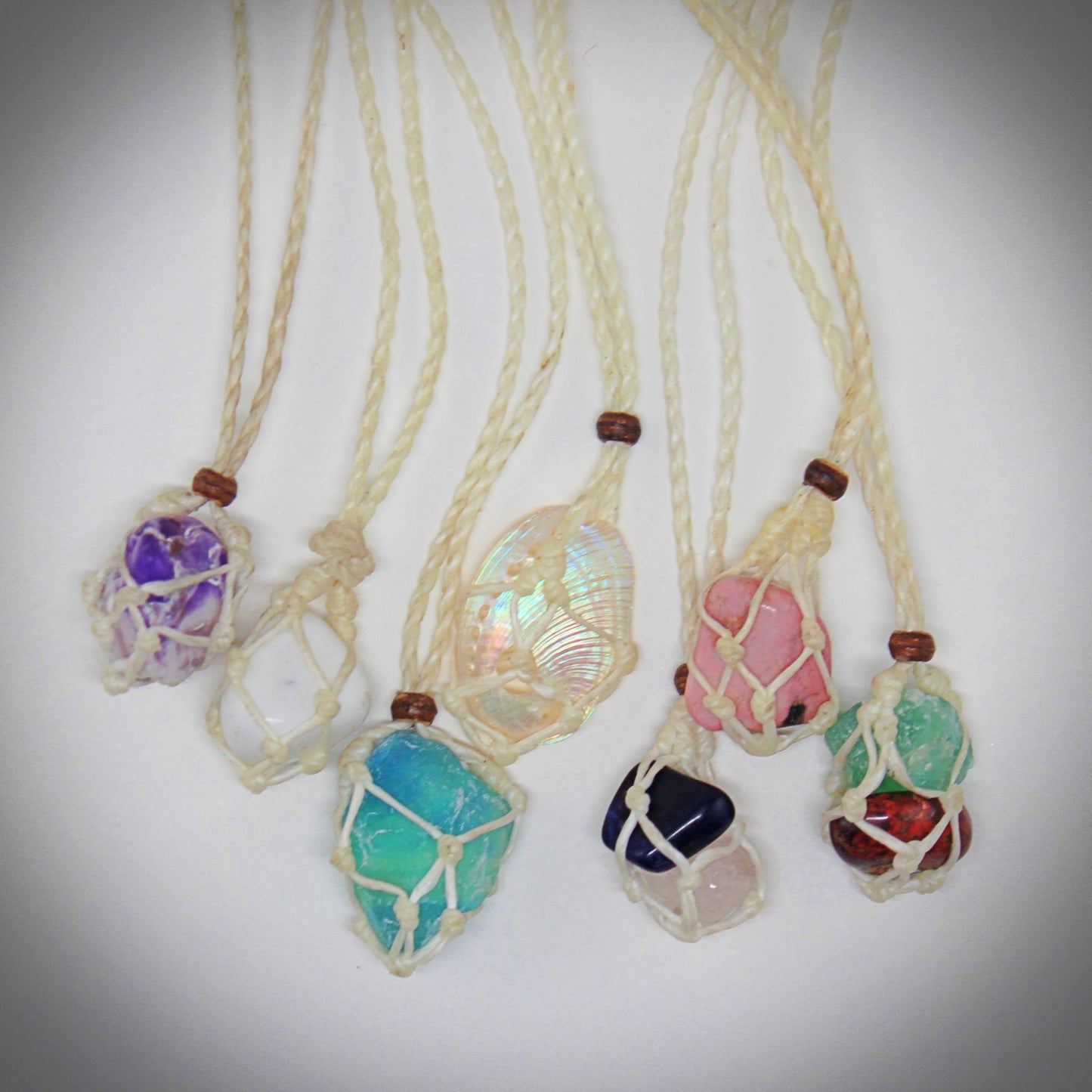 Handmade interchangeable macramé cage necklaces with tumbled stone