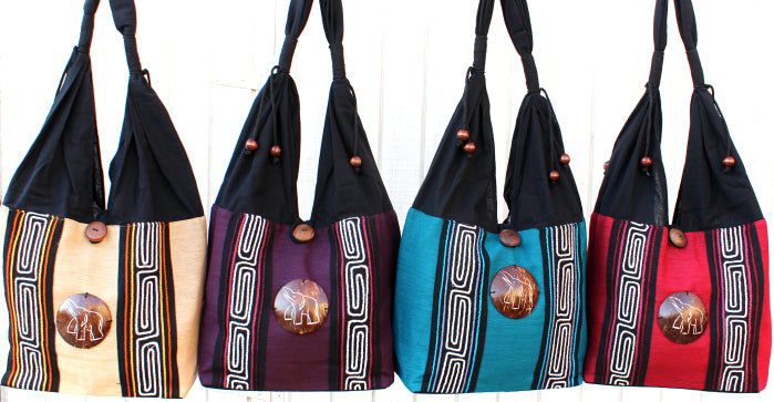 Handmade Cotton shoulder bag with hand embroidered design and hand-craved coconut shell accent